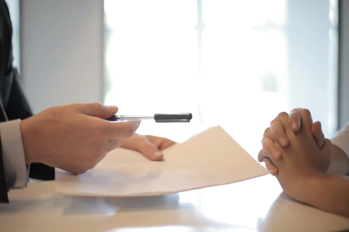 Free Crop businessman giving contract to woman to sign Stock Photo